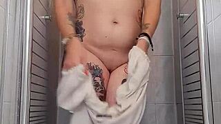 Blonde Alina bathes naked in shower, touching her sexy body