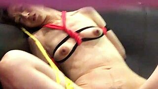 Miki humiliated and restrained on a hotel couch while streaming adult videos