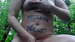 slut masturbates outdoor in bdsm forest