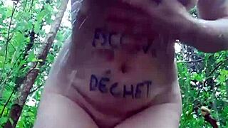 slut masturbates outdoor in bdsm forest