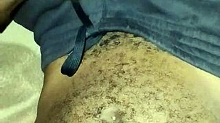 gay twink stroking his big hairy cock at home