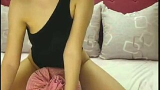 Webcam brunette dances in unitard grinding on pillow