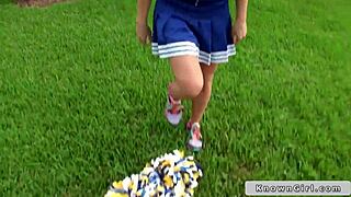 A busty cheerleader is flashing her boobs outdoors to everyone