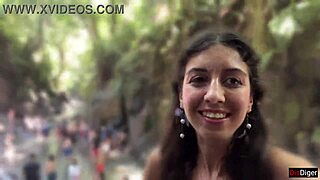 in the public locker room, she gets cum on her face, then walks to the waterfall with it