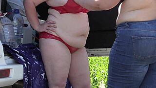 Mature lesbians flash big asses outdoors in lingerie. Voyeur watches with hidden camera in public park fetish scene.