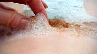 Annie bathes her big tits in the tub