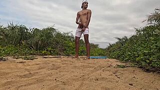 African guy gets handjob and cums on the beach
