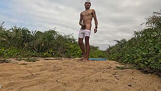 African guy gets handjob and cums on the beach