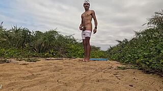 African guy gets handjob and cums on the beach