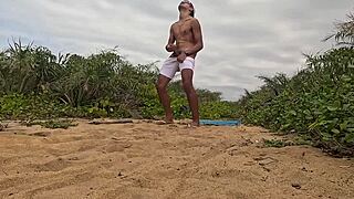 African guy gets handjob and cums on the beach