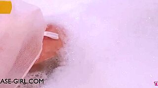 Enchanting brunette muse relaxes in sensual bath