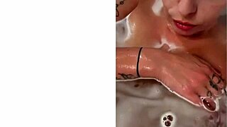 milf shows off big tits and tattoo from behind