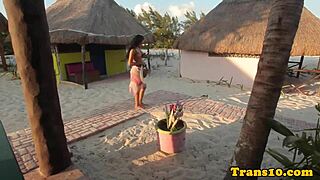 Glamorous tattooed Latina relaxes in the shower wearing a bikini