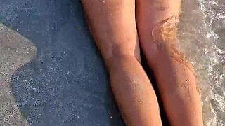 girl flashes on the beach in her sexy white bikini