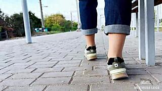 tan nylon soles peek from blue jeans on the bench