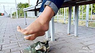 tan nylon soles peek from blue jeans on the bench