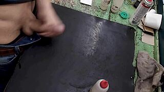 skinny young amateur masturbates big cock on workbench at work