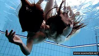 Shaved brunette with big tits underwater?