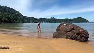 Beach couple shares passionate kisses and close-up fun by the waves.