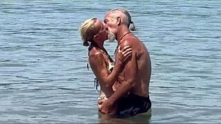 Beach couple shares passionate kisses and close-up fun by the waves.