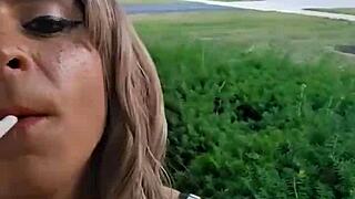 crossdressed sissy slut smokes cigarette outside house at dawn