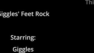 giggles rubs bare feet all over giant hot beach rock closeup