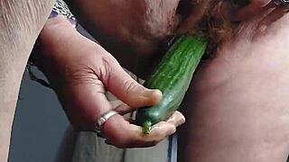 granny stuffs hairy pussy with thick cucumber solo