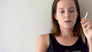Petite brunette babe smokes hot while teasing blue eyes voyeur