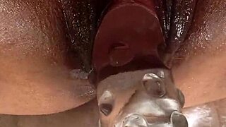 Who's stuffing this huge black pussy with that giant dildo next?