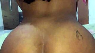 the brunette flashes her huge natural tits in fishnets before teasing her pierced nipples