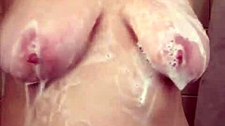 big boob mama hops in shower washing hair then shaves smooth