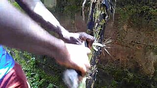 Young oiled beauty pleasures herself with plantain deep in the garden