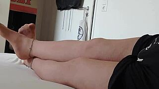 Nylon boy in nightgown and pantyhose teases with feet and legs close-up