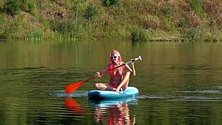 Skinny tall babe flashes pink micro bikini outdoors at beach garden