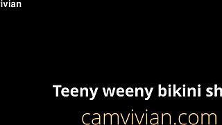 tiny bikini strip shows off puffy shaved teen cameltoe 😍