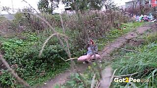 pretty brunette squats low to pee publicly in lush outdoor nature spot