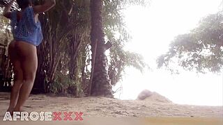 black girl on beach teases with her hot ebony curves