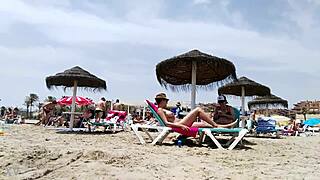 Brunette's huge tits bounce wildly on the beach