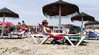Brunette's huge tits bounce wildly on the beach