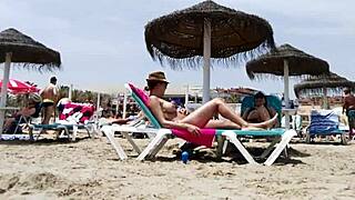 Brunette's huge tits bounce wildly on the beach