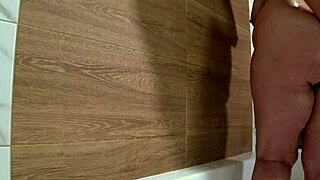 Bathroom camera watches mature wife shower